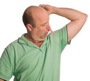 Man with sweating underarms and a peg on his nose